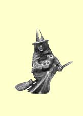 A figue of a witch fying on a broomstick, solid metal.